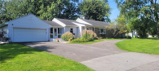 ranch-style home with a front lawn and a garage