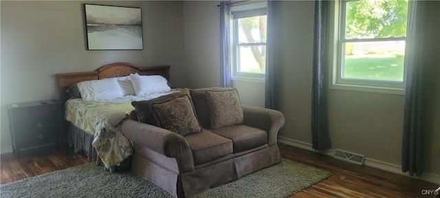 bedroom with dark wood-type flooring