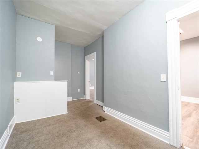 spare room with light colored carpet