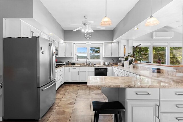 kitchen with hanging light fixtures, stainless steel fridge, white cabinets, and kitchen peninsula