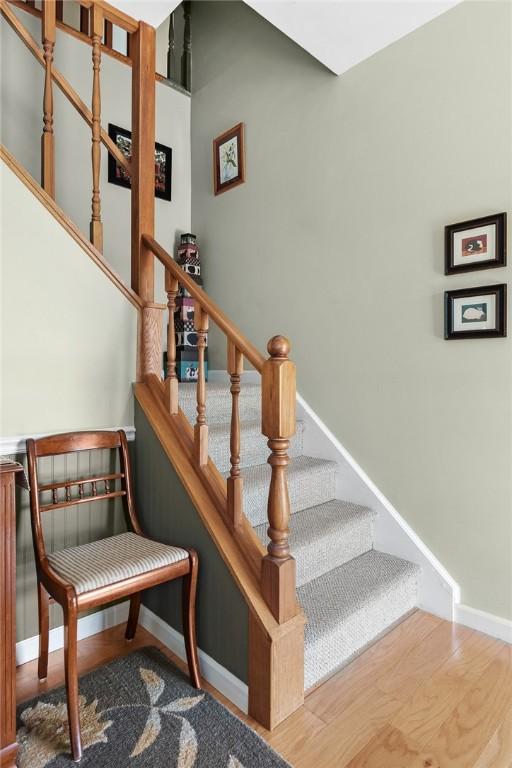 stairs with hardwood / wood-style flooring