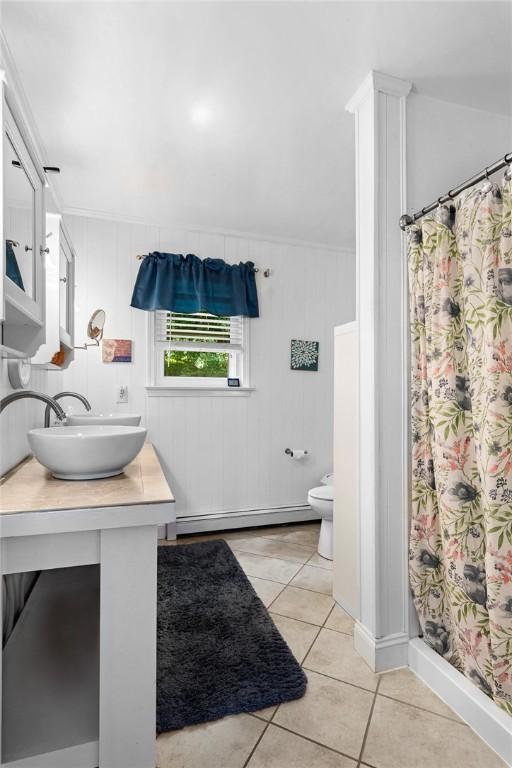 bathroom with tile patterned floors, toilet, a baseboard radiator, a shower with shower curtain, and vanity