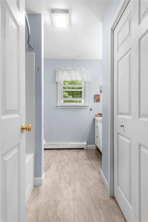 bathroom with vanity, a baseboard radiator, and shower / bath combination