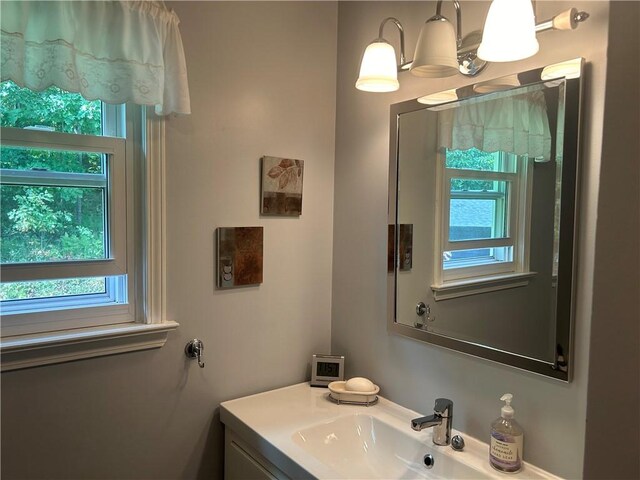 bathroom with vanity and a chandelier