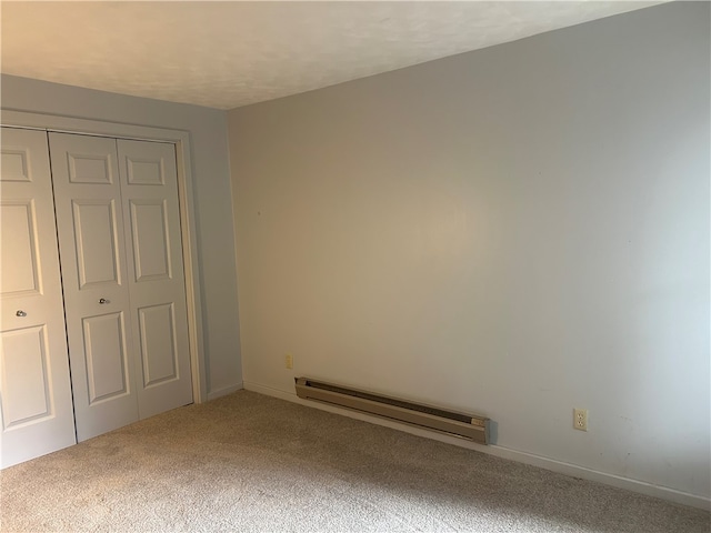 unfurnished bedroom with a closet, a baseboard radiator, and carpet floors