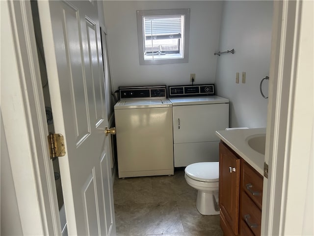 bathroom with vanity, toilet, and washer and clothes dryer