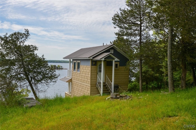 view of outbuilding with a water view