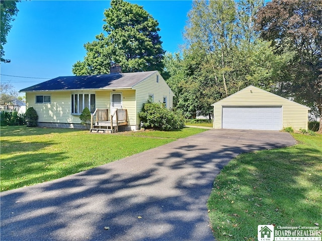 view of front of house with a garage, a front lawn, and an outdoor structure