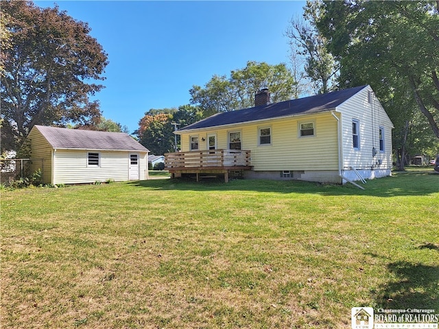 rear view of house featuring a yard and a wooden deck