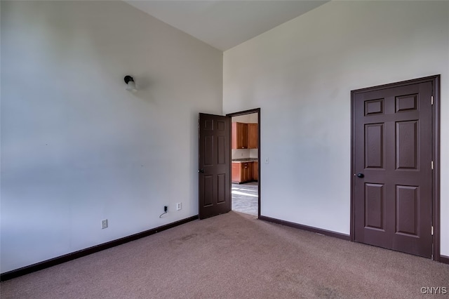 unfurnished bedroom featuring light carpet