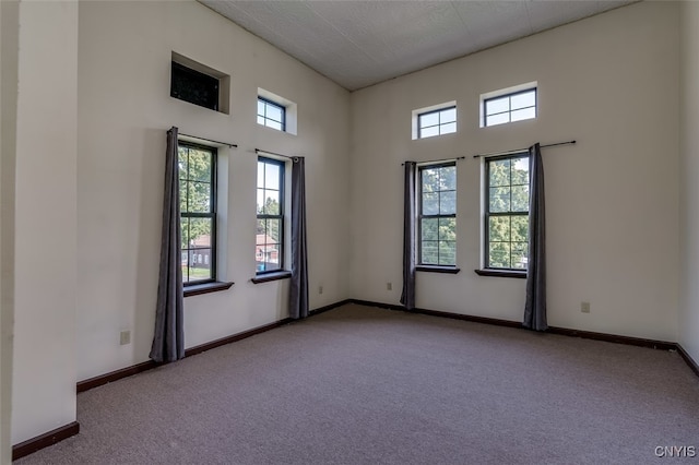 carpeted spare room featuring a textured ceiling