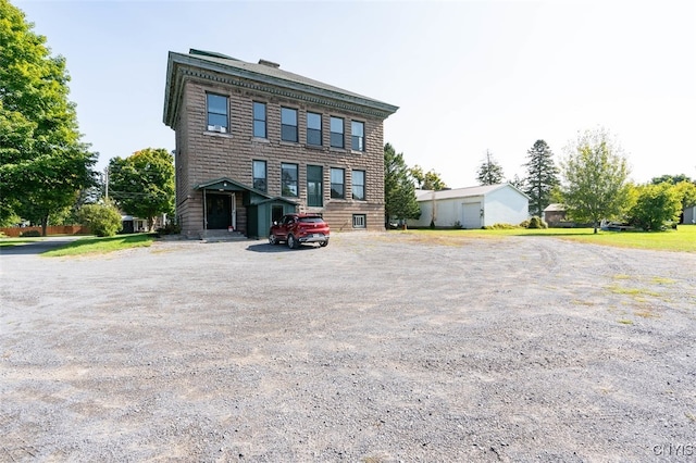 back of property with an outbuilding and a garage