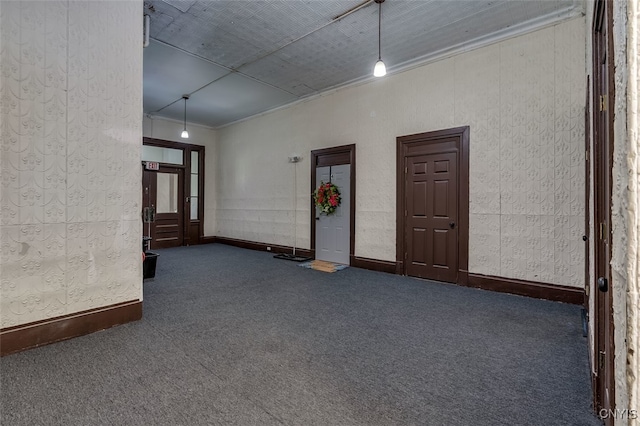 empty room featuring dark carpet