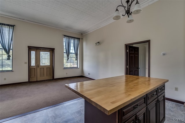 kitchen with plenty of natural light, a kitchen island, and butcher block countertops