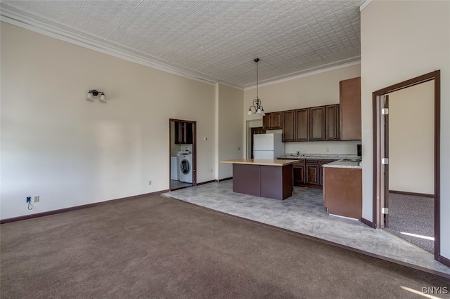 kitchen with dark colored carpet, a kitchen island, decorative light fixtures, and white fridge