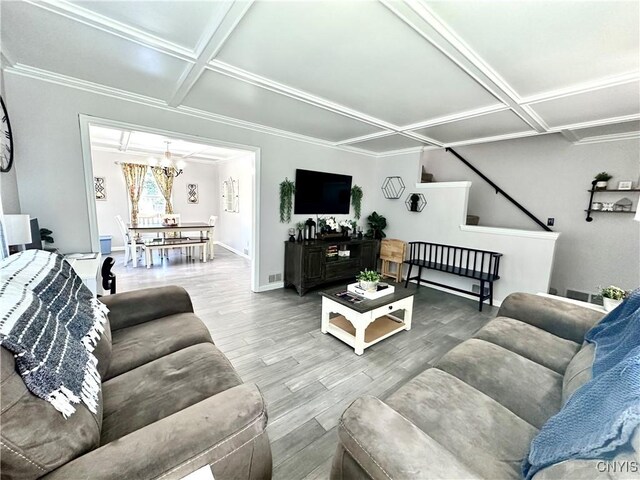 living room featuring crown molding, coffered ceiling, and hardwood / wood-style flooring