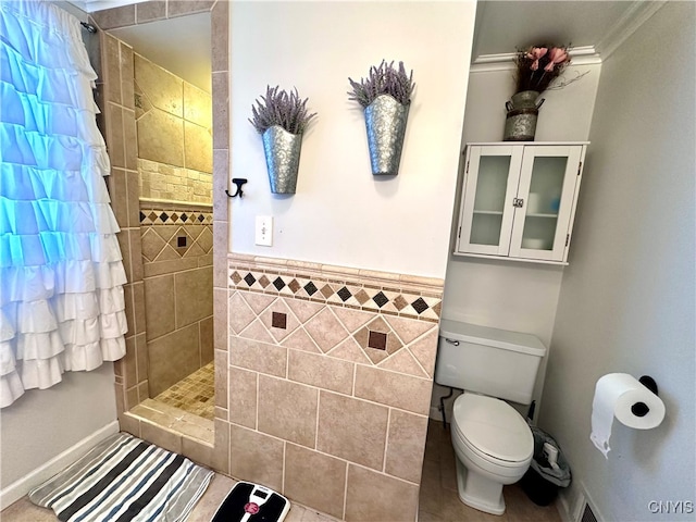 bathroom with tile walls, toilet, and a shower with curtain