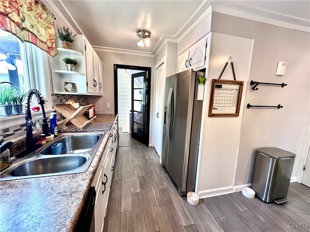 kitchen featuring a wealth of natural light, white cabinetry, hardwood / wood-style floors, and stainless steel fridge with ice dispenser