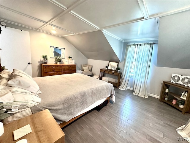 bedroom with wood-type flooring, ornamental molding, and vaulted ceiling