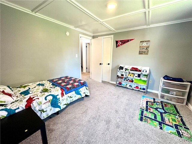 carpeted bedroom with coffered ceiling and ornamental molding