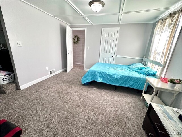 carpeted bedroom with coffered ceiling