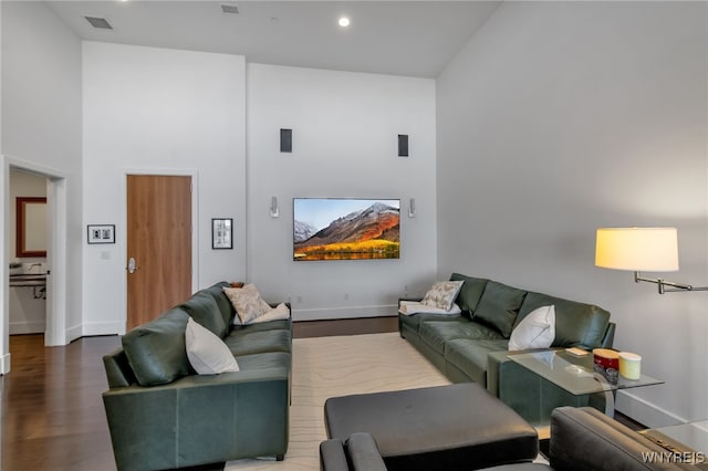 living room with high vaulted ceiling and hardwood / wood-style floors