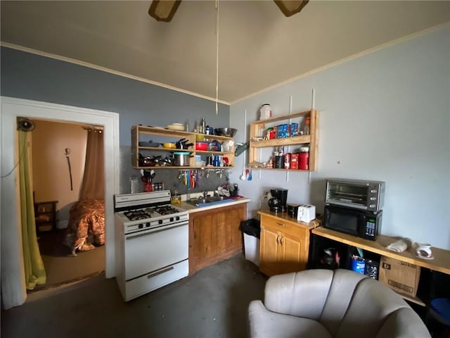 kitchen featuring black microwave, a sink, light countertops, ornamental molding, and white range with gas cooktop