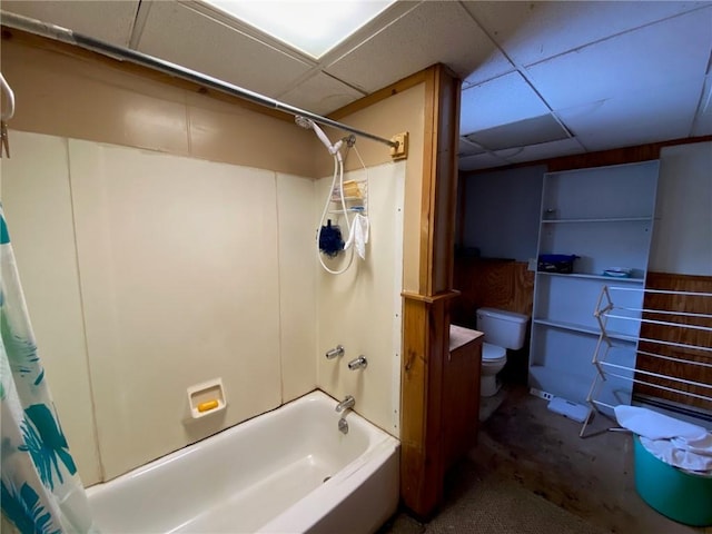 full bath featuring toilet, shower / bathtub combination with curtain, and a paneled ceiling