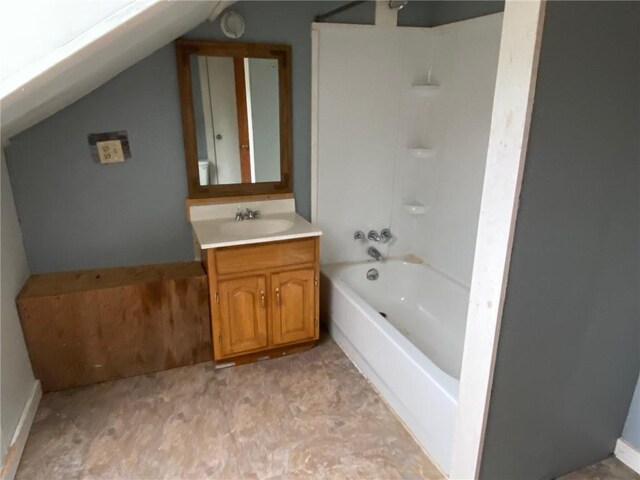 full bathroom with vanity, vaulted ceiling, and shower / washtub combination