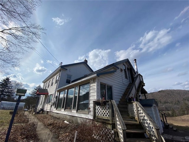 view of property exterior featuring a sunroom