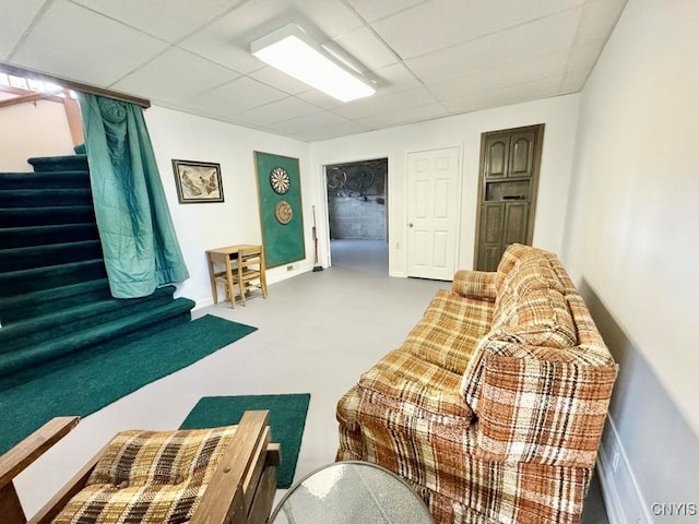 carpeted living room featuring a paneled ceiling