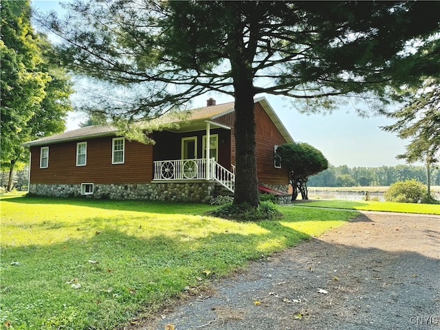 view of front facade with a front yard and a porch