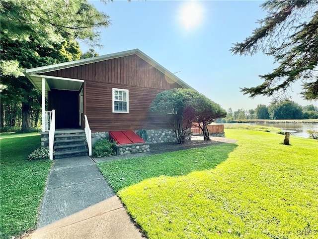 view of front of property with a front yard and a water view