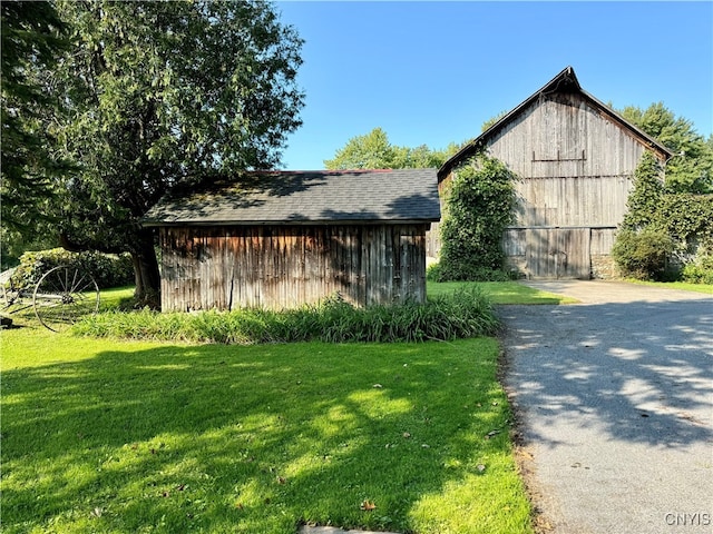 view of front facade with an outbuilding and a front lawn