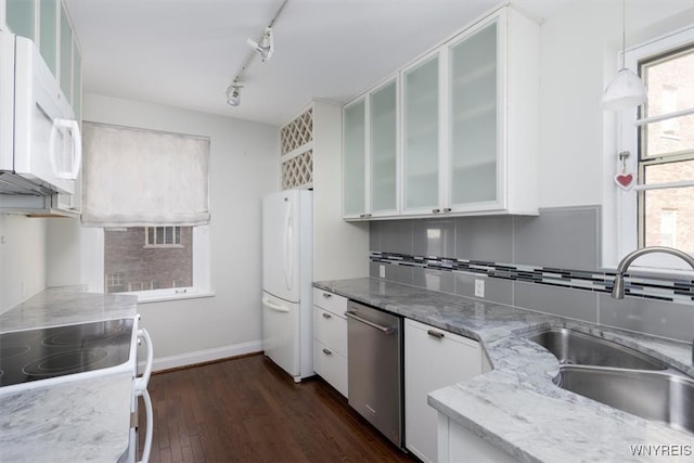 kitchen featuring white appliances, white cabinetry, sink, and dark hardwood / wood-style floors