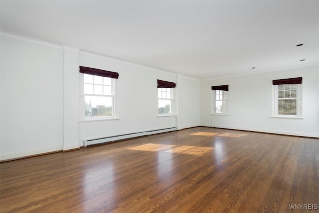 spare room featuring dark hardwood / wood-style floors and baseboard heating