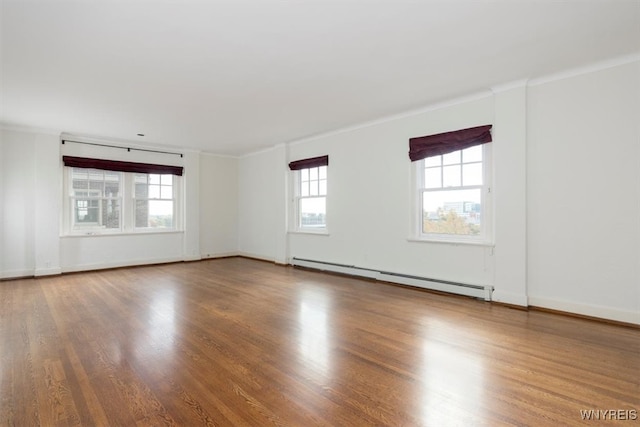 unfurnished room with ornamental molding, baseboard heating, and hardwood / wood-style floors