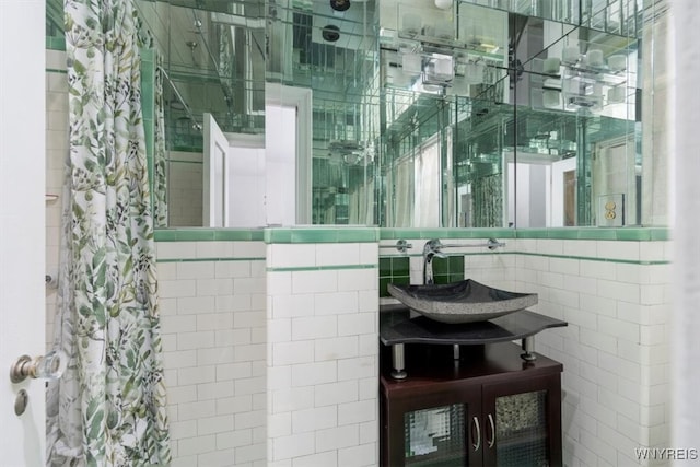 bathroom featuring tile walls and sink