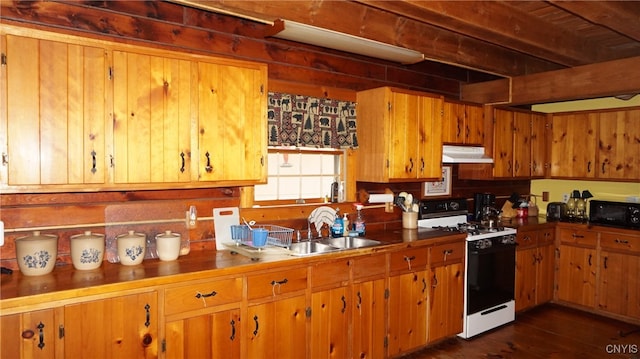 kitchen featuring dark hardwood / wood-style floors, white gas range oven, and sink