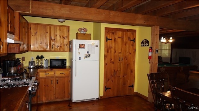 kitchen featuring beamed ceiling, white appliances, a notable chandelier, and dark hardwood / wood-style floors