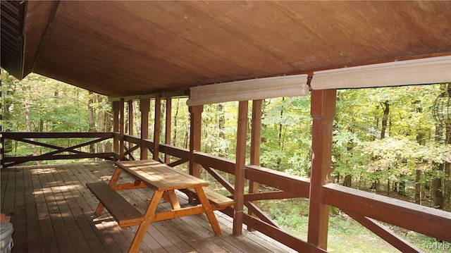 unfurnished sunroom featuring vaulted ceiling and wooden ceiling