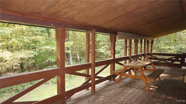 unfurnished sunroom with wood ceiling