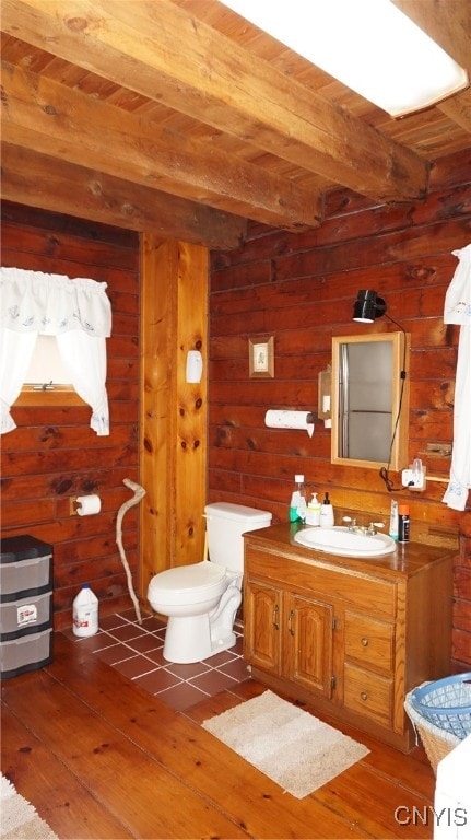 bathroom with wood ceiling, toilet, beamed ceiling, wood-type flooring, and vanity