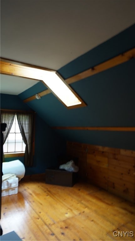 additional living space with lofted ceiling and wood-type flooring