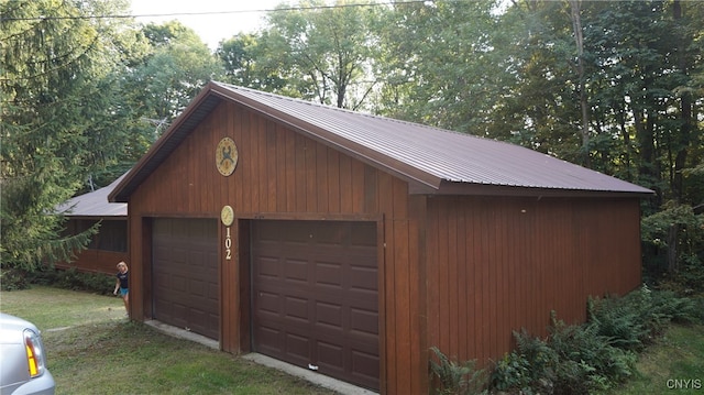 garage featuring wood walls