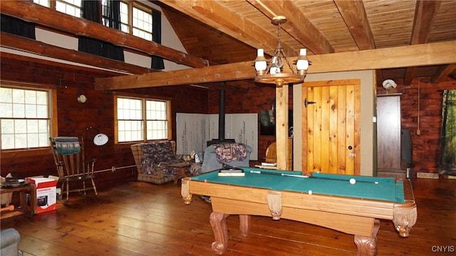 recreation room with billiards, a wood stove, a notable chandelier, and dark hardwood / wood-style flooring