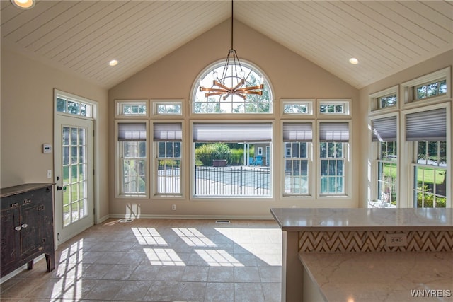 unfurnished sunroom featuring vaulted ceiling and plenty of natural light