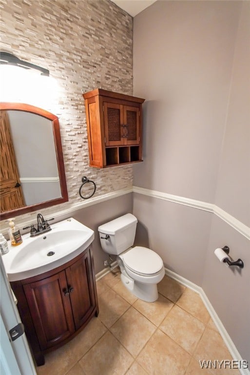 bathroom with vanity, toilet, and tile patterned floors