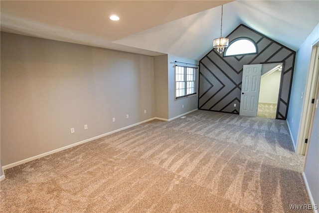 interior space featuring an inviting chandelier, carpet, and vaulted ceiling