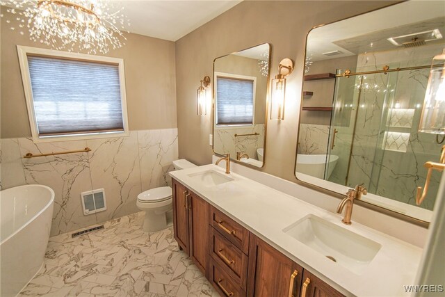 full bathroom featuring toilet, plus walk in shower, vanity, a chandelier, and tile walls